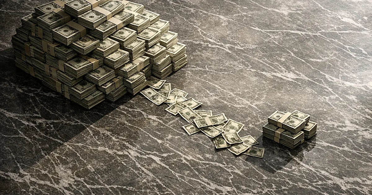 Two unequal stacks of cash on marble surface showing financial disparity between competing sides